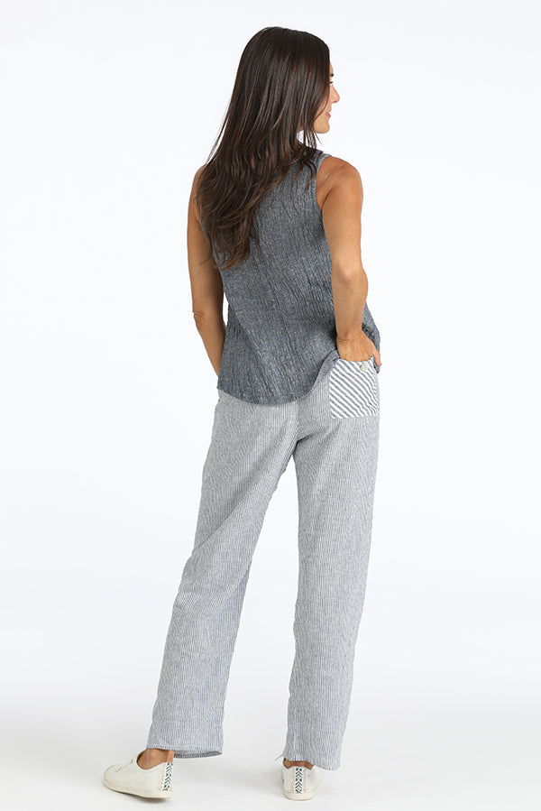 Woman wearing  striped linen pants with a contrast back pocket