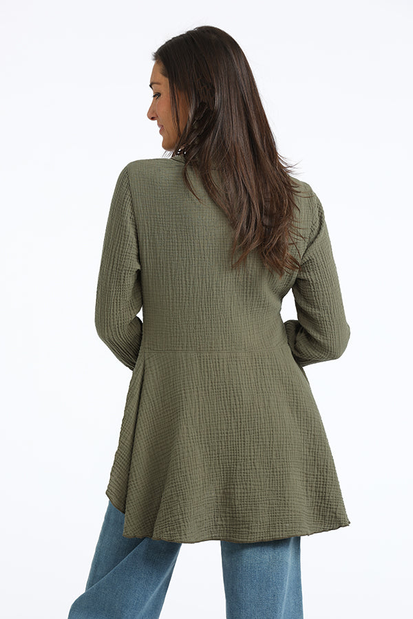 Woman wearing a green gauze jacket on a white background